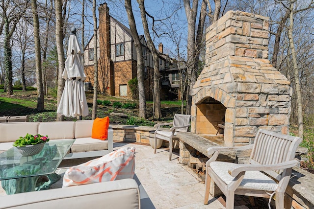 view of patio with an outdoor living space with a fireplace