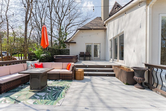 deck with a hot tub and an outdoor living space