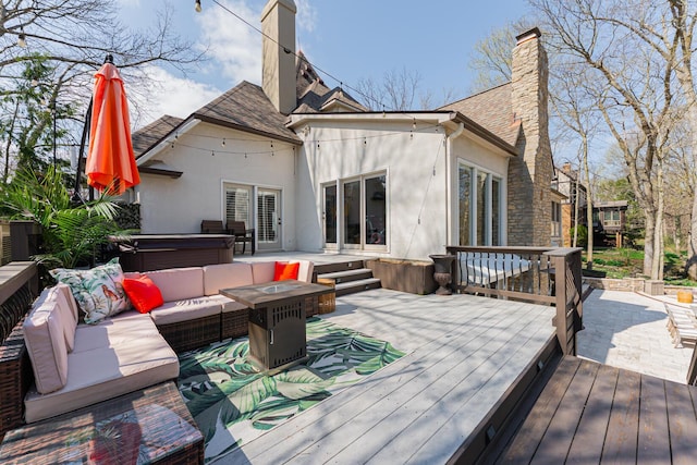 wooden deck featuring a hot tub and an outdoor living space