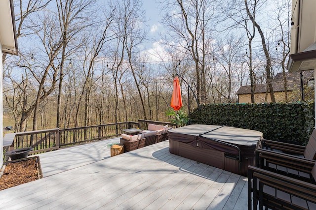 wooden deck featuring a covered hot tub