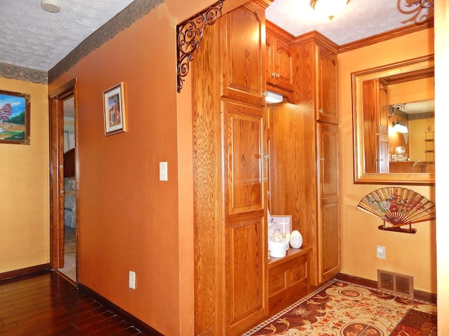3061 County Road 11, Bellefontaine, OH 43311 - corridor featuring a textured ceiling, dark wood-style flooring, baseboards, and ornamental molding