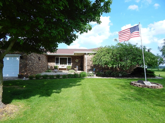 3061 County Road 11, Bellefontaine, OH 43311 - view of front of house with a front yard, brick siding, and an attached garage