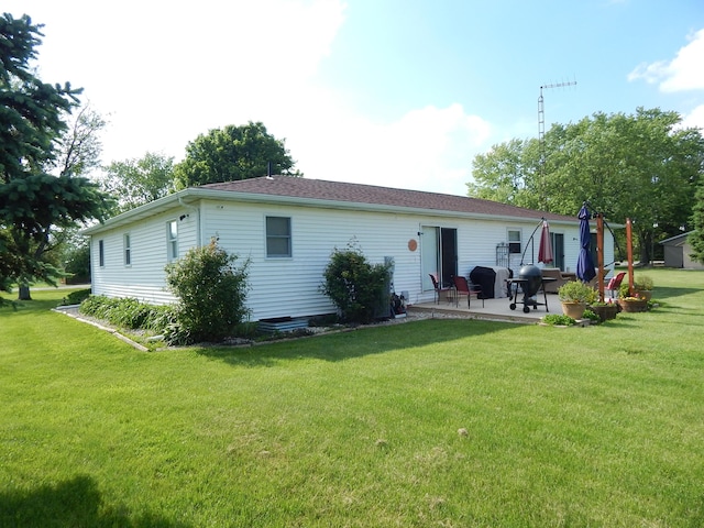 3061 County Road 11, Bellefontaine, OH 43311 - rear view of house with a patio area and a yard
