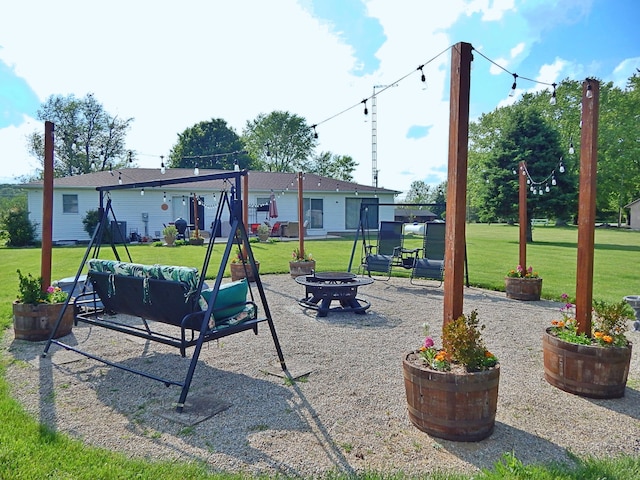 3061 County Road 11, Bellefontaine, OH 43311 - view of playground featuring an outdoor fire pit, a patio, and a lawn