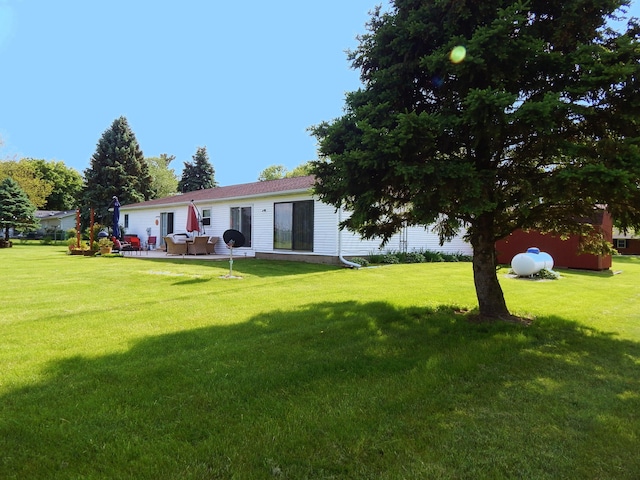 3061 County Road 11, Bellefontaine, OH 43311 - rear view of property featuring a yard and a patio area