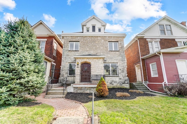 view of front of home with a front lawn and stone siding
