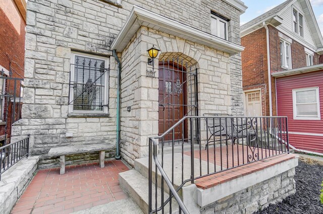 view of exterior entry featuring stone siding