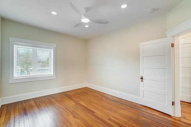 spare room with a ceiling fan, hardwood / wood-style flooring, baseboards, and recessed lighting