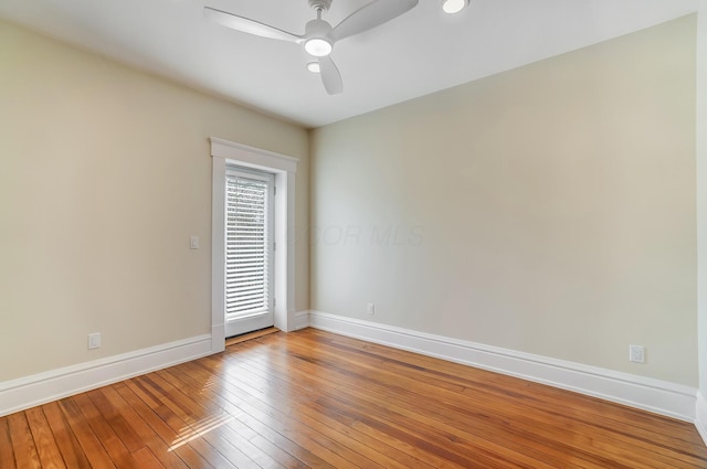 empty room with baseboards, a ceiling fan, and light wood finished floors