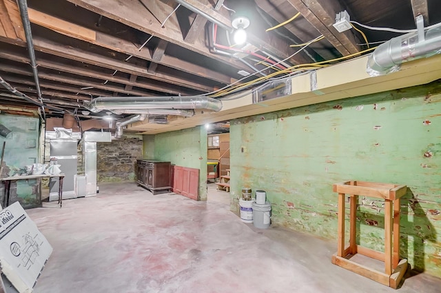 unfinished below grade area featuring heating unit