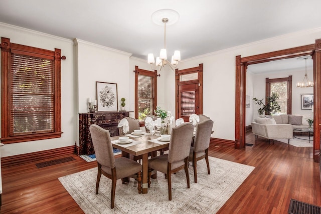 160 E Moler St, Columbus, OH 43207 - dining area with a chandelier, baseboards, ornamental molding, and dark wood-style floors