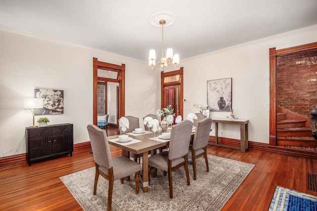 160 E Moler St, Columbus, OH 43207 - dining space featuring a chandelier, crown molding, wood finished floors, and baseboards