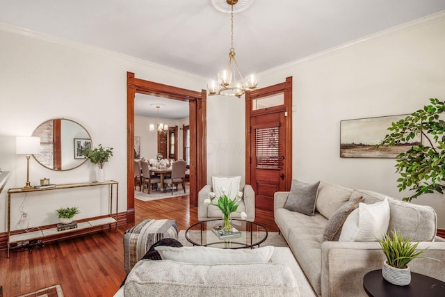 160 E Moler St, Columbus, OH 43207 - living room featuring a chandelier, baseboards, wood finished floors, and crown molding