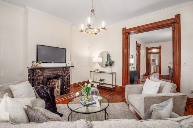 160 E Moler St, Columbus, OH 43207 - living area with wood finished floors, a chandelier, baseboards, ornamental molding, and a high end fireplace