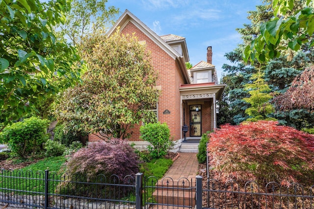 160 E Moler St, Columbus, OH 43207 - view of front of property with brick siding, a fenced front yard, and a chimney