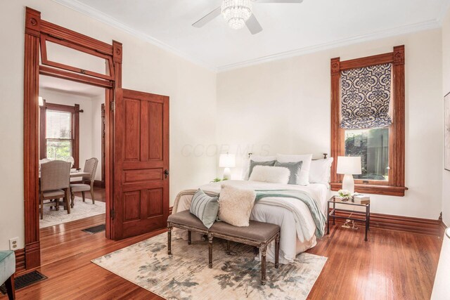 160 E Moler St, Columbus, OH 43207 - bedroom featuring wood finished floors, crown molding, baseboards, and a ceiling fan