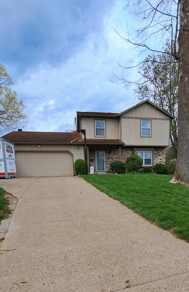 505 Marion Mnr, Woods, Newark, OH 43055 - view of front of house with concrete driveway, a front lawn, and a garage