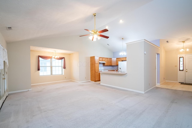 unfurnished living room featuring baseboards, visible vents, ceiling fan with notable chandelier, and light colored carpet