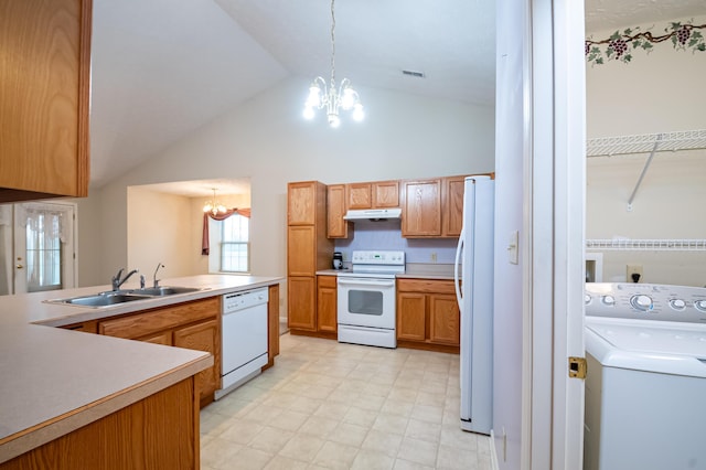 kitchen with white appliances, under cabinet range hood, a sink, an inviting chandelier, and washer / dryer