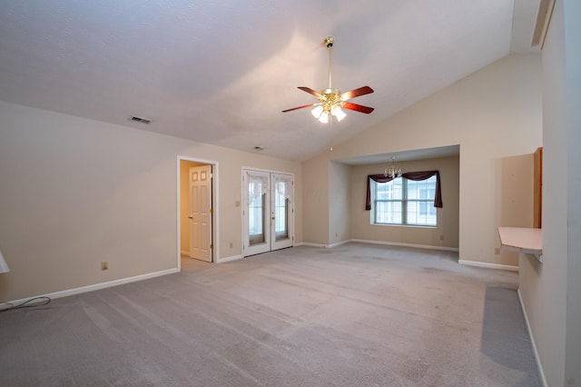 unfurnished living room featuring light carpet, ceiling fan with notable chandelier, visible vents, and baseboards