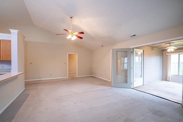 unfurnished living room featuring light colored carpet, lofted ceiling, and a ceiling fan