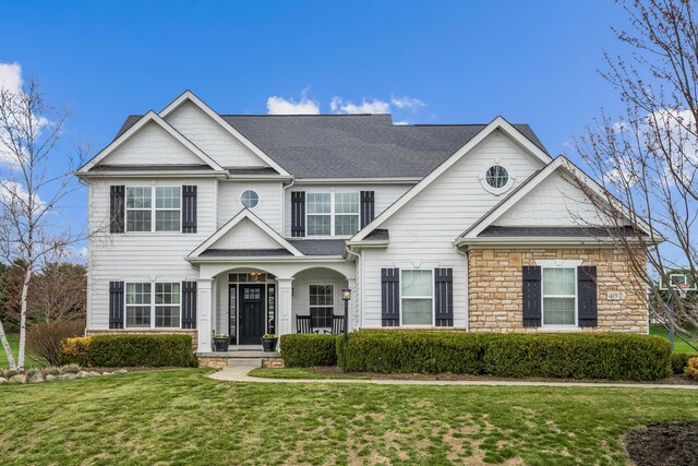 view of front facade with a front lawn and stone siding