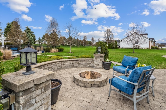 view of patio featuring a fire pit and fence