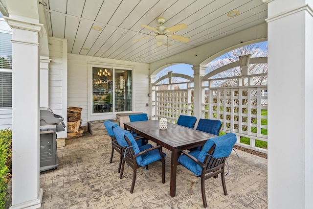 view of patio featuring area for grilling, a ceiling fan, and outdoor dining area