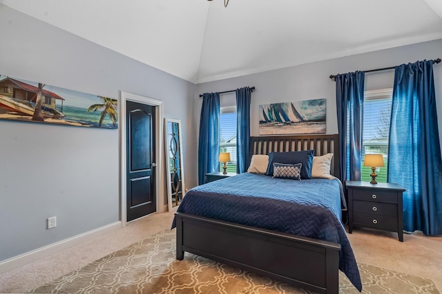 bedroom with light carpet, baseboards, and lofted ceiling