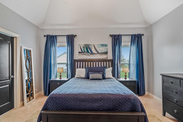 bedroom with baseboards, lofted ceiling, and carpet