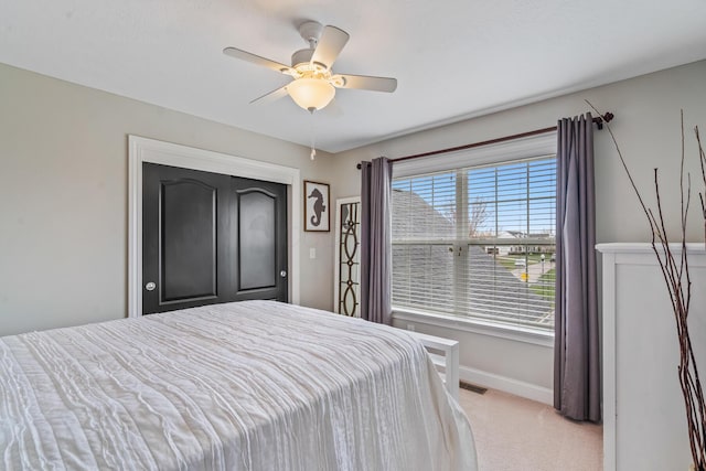 bedroom featuring carpet, baseboards, ceiling fan, and visible vents