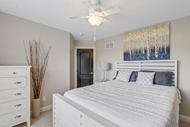 bedroom featuring baseboards, visible vents, a ceiling fan, and light carpet
