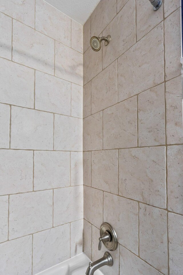 details featuring shower / washtub combination