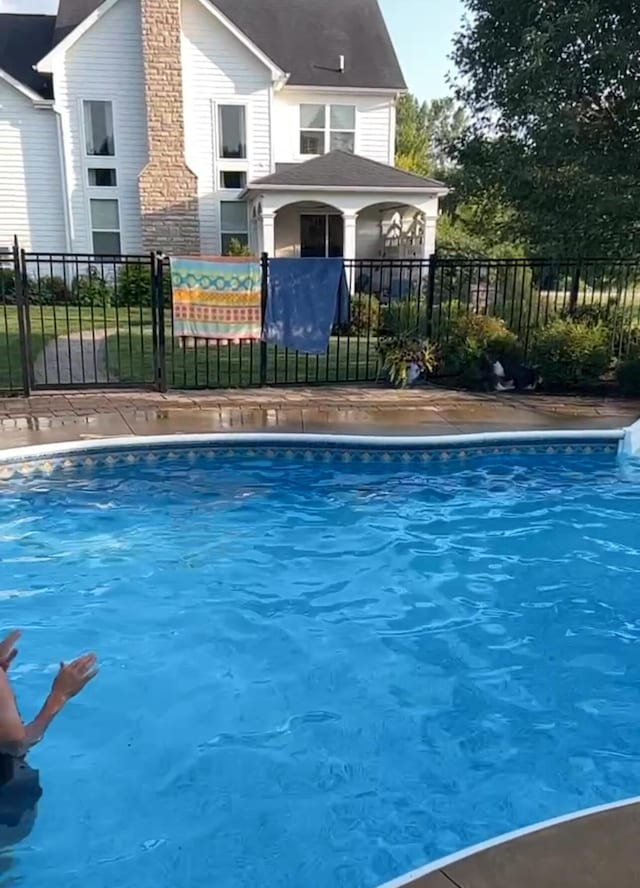 view of swimming pool featuring fence and a fenced in pool