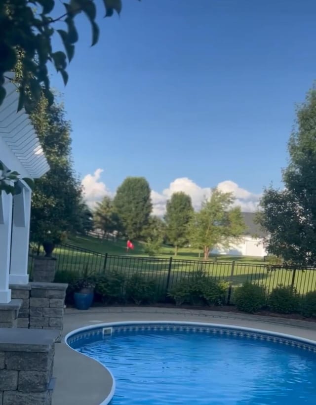 view of swimming pool featuring a fenced in pool and fence