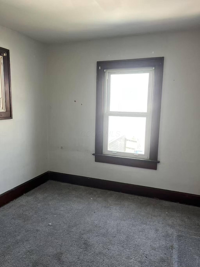 spare room with carpet flooring and baseboards