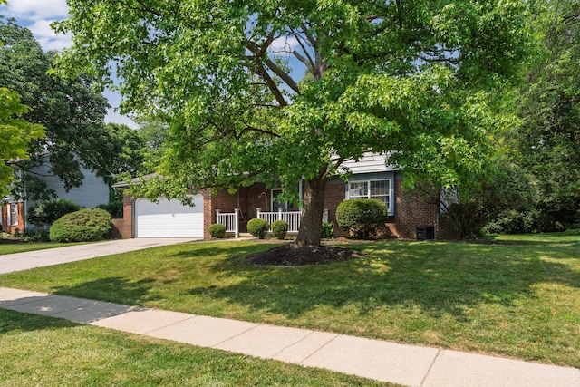 2520 Saltergate Dr, Dublin, OH 43016 - obstructed view of property featuring brick siding, concrete driveway, a front lawn, and a garage