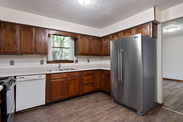 2520 Saltergate Dr, Dublin, OH 43016 - kitchen featuring high quality fridge, white dishwasher, a textured ceiling, light countertops, and black range
