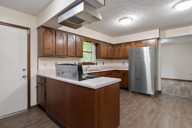 2520 Saltergate Dr, Dublin, OH 43016 - kitchen with high quality fridge, a peninsula, island exhaust hood, dark wood-style flooring, and light countertops