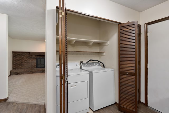 2520 Saltergate Dr, Dublin, OH 43016 - washroom featuring wood finished floors, washing machine and clothes dryer, and a textured ceiling