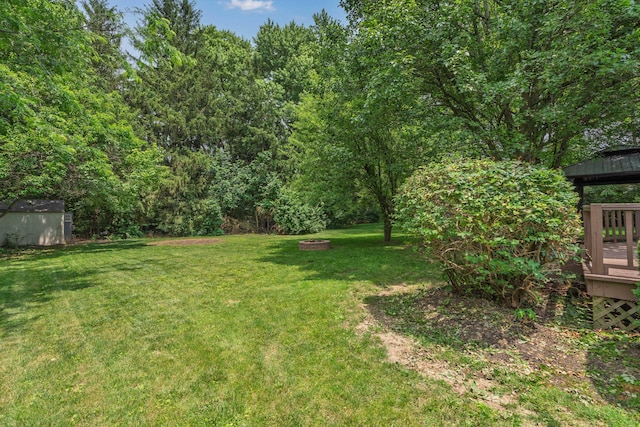 2520 Saltergate Dr, Dublin, OH 43016 - view of grassy yard with a shed, a gazebo, a deck, and an outdoor fire pit