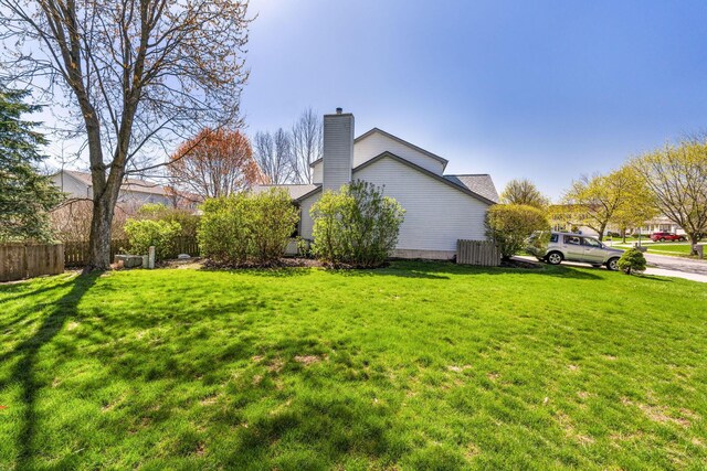 632 Tall Oaks Dr, Gahanna, OH 43230 - view of property exterior with a lawn, fence, and a chimney