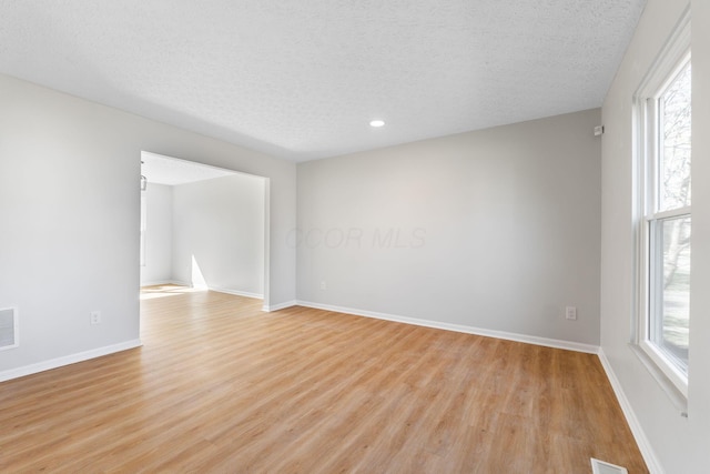 632 Tall Oaks Dr, Gahanna, OH 43230 - spare room with light wood-type flooring, a textured ceiling, visible vents, and a wealth of natural light