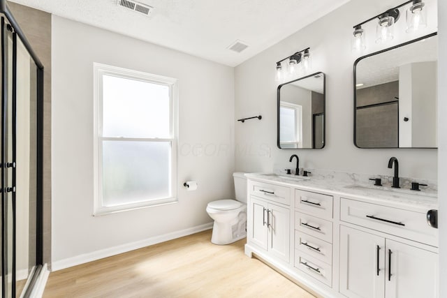632 Tall Oaks Dr, Gahanna, OH 43230 - full bathroom with a sink, toilet, wood finished floors, and visible vents