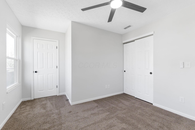 632 Tall Oaks Dr, Gahanna, OH 43230 - unfurnished bedroom featuring visible vents, carpet flooring, a textured ceiling, and baseboards