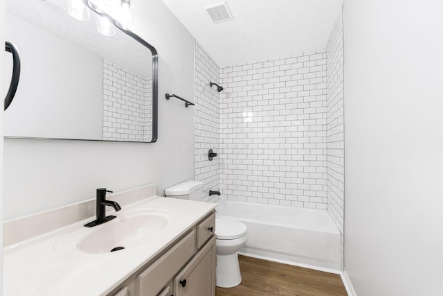 632 Tall Oaks Dr, Gahanna, OH 43230 - bathroom with a textured ceiling, visible vents, wood finished floors, vanity, and toilet