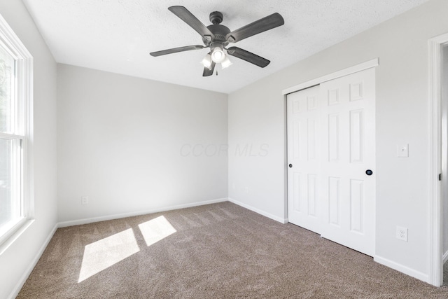 632 Tall Oaks Dr, Gahanna, OH 43230 - unfurnished bedroom featuring carpet floors, baseboards, multiple windows, and a closet