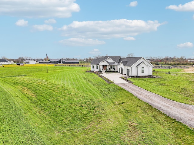 exterior space featuring fence, driveway, and a front yard