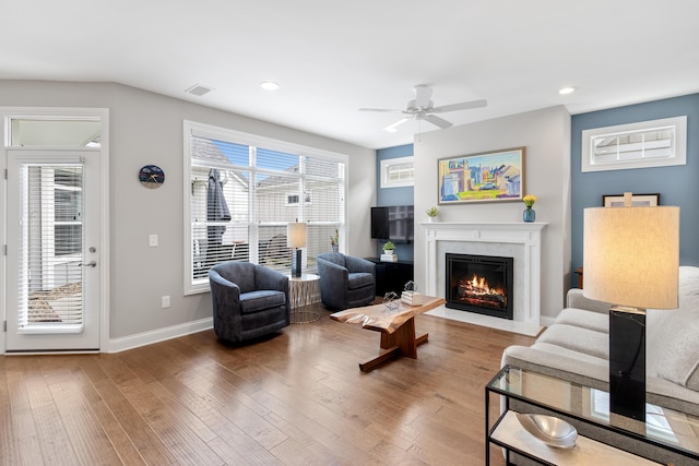 3325 Strickland Dr, New Albany, OH 43054 - living area with visible vents, recessed lighting, a ceiling fan, wood finished floors, and a high end fireplace