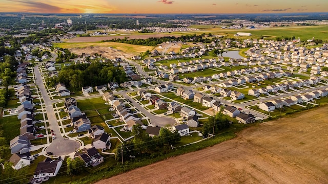 aerial view at dusk featuring a residential view